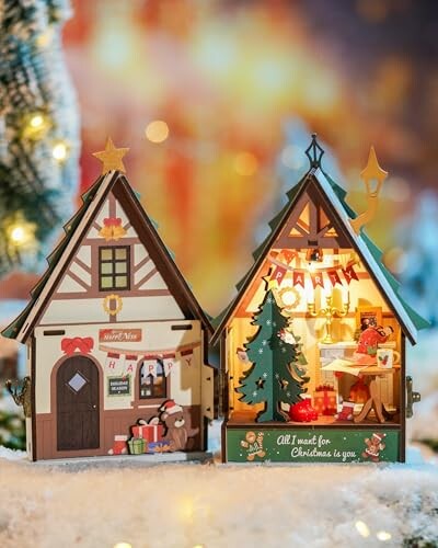 Decorative Christmas houses with festive lights and gifts.