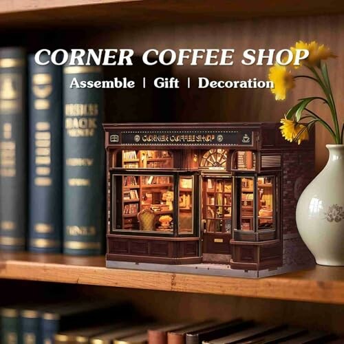 Miniature coffee shop model on a bookshelf.