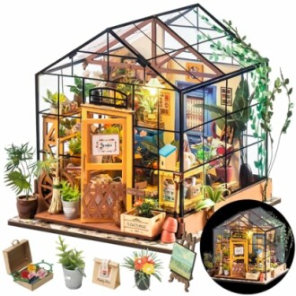 Miniature DIY greenhouse kit with plants and furniture.