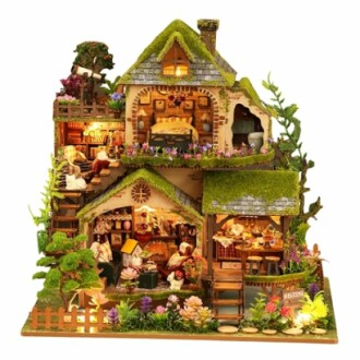 Miniature dollhouse with garden and detailed rooms.