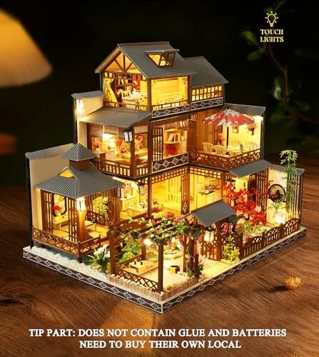 Illuminated miniature dollhouse kit with multiple rooms and gardens.
