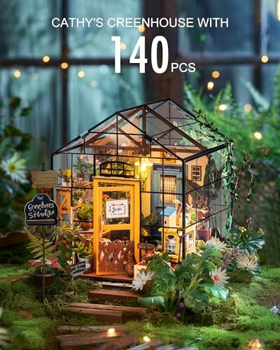 Miniature greenhouse kit with 140 pieces, surrounded by plants.