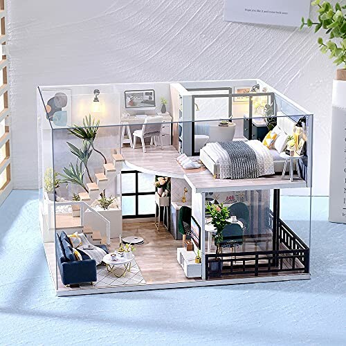 Miniature model of a modern two-story house with detailed interior design.