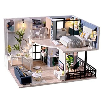 Modern miniature dollhouse with living room, bedroom, and office space.
